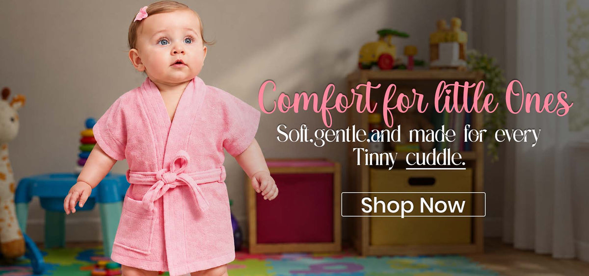Baby wearing a pink cotton bathrobe with belt in a colorful playroomslider_item_9FbnhY