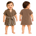 A toddler standing against a plain white background, shown from the front and back wearing a short-sleeve brown bathrobe with a white belt and front patch pockets.