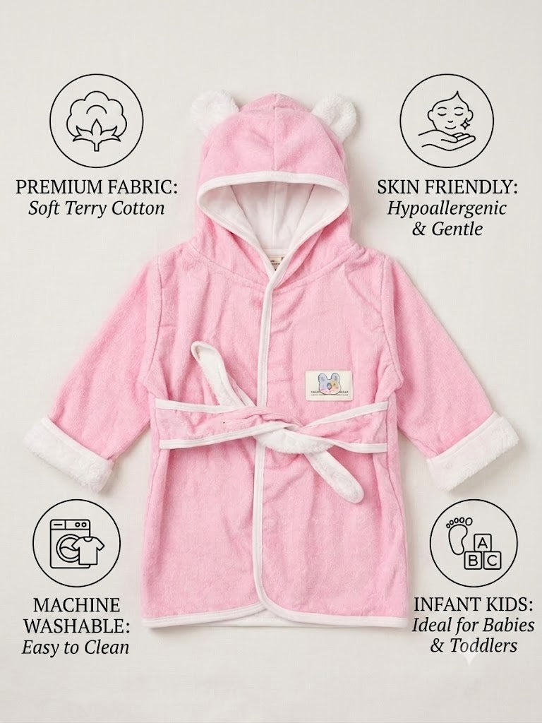 A pink baby hooded bathrobe with white trim and ear details on the hood, shown on a light beige background with feature callout icons and text for fabric, skin friendliness, washability, and suitability for infants and toddlers.