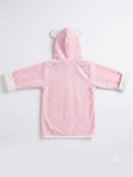 A pink hooded robe or bathrobe shown from the back, laid flat on a light gray background. The hood has small white bear-ear shapes, and the cuffs and hem are trimmed in white.