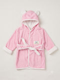 A pink hooded bathrobe with white trim, featuring plush bear ears on the hood, a white tie belt, and a small embroidered patch on the chest, displayed against a light beige background.