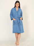 Woman wearing a blue robe on a plain background