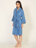 Woman wearing a blue striped robe on a beige background