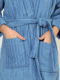 Blue robe with pockets and a tie waist on a neutral background