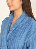 Woman wearing a blue robe with a neutral background