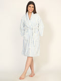 Woman wearing a striped robe on a plain background
