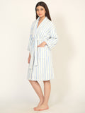 Woman wearing a striped robe on a plain background