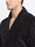 Close-up of a man wearing a black cotton bathrobe with a tie belt