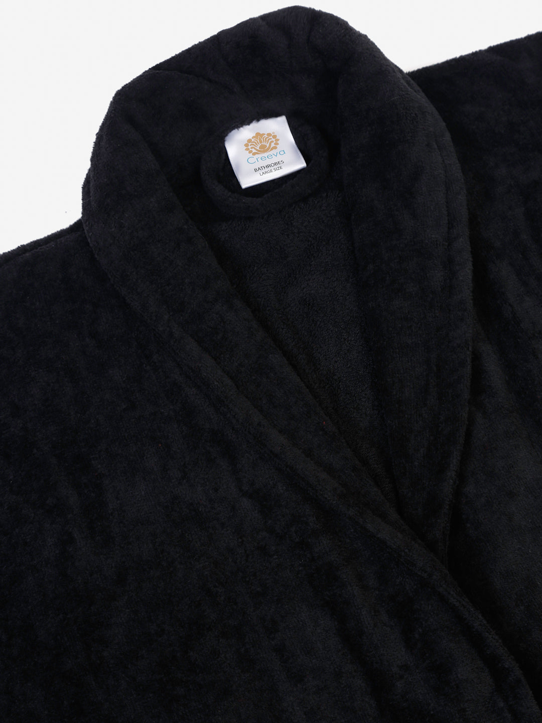 Close-up of a black cotton bathrobe showing the collar and fabric texture