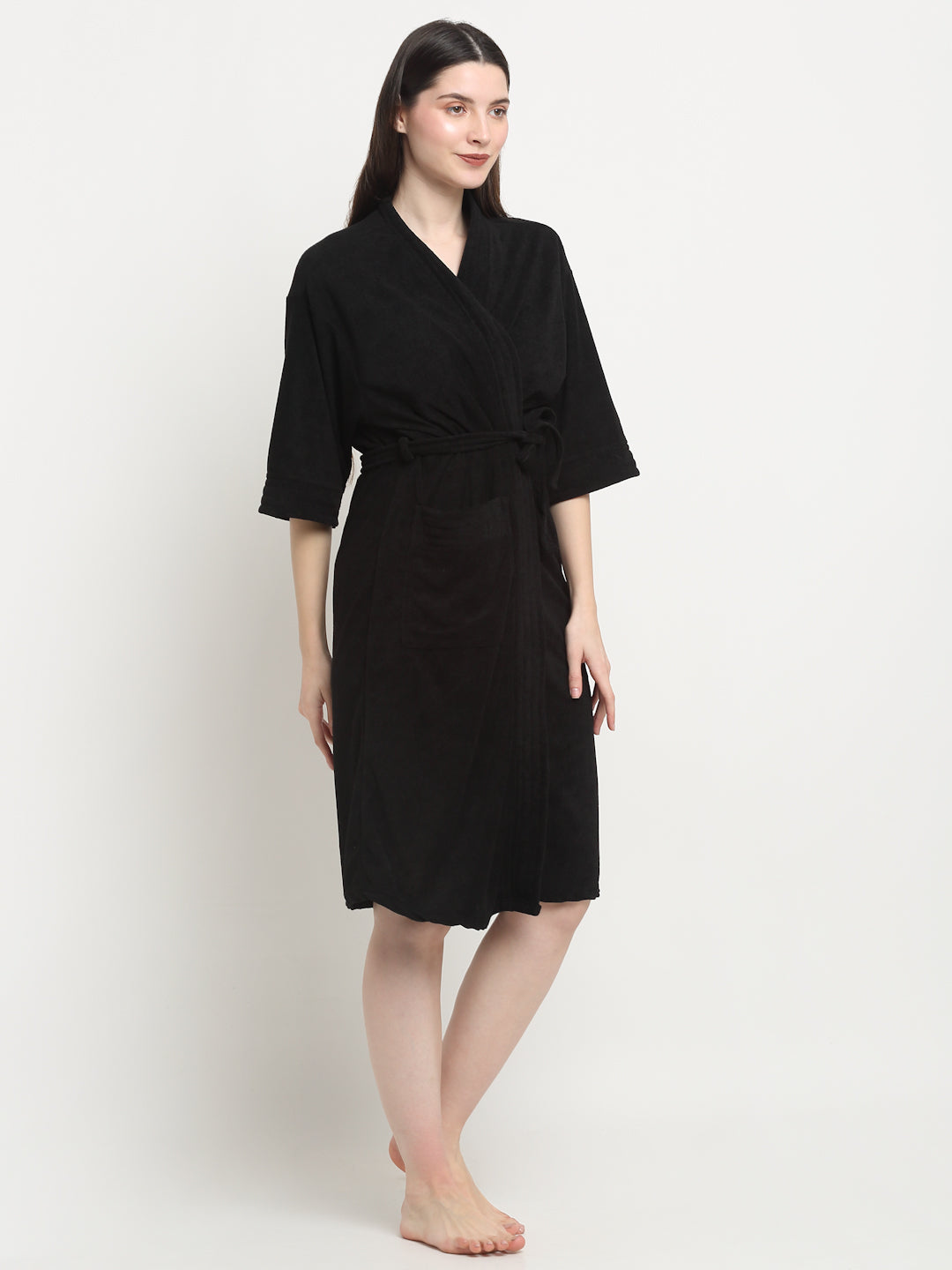 Woman wearing a black micro terry bathrobe with a tie belt