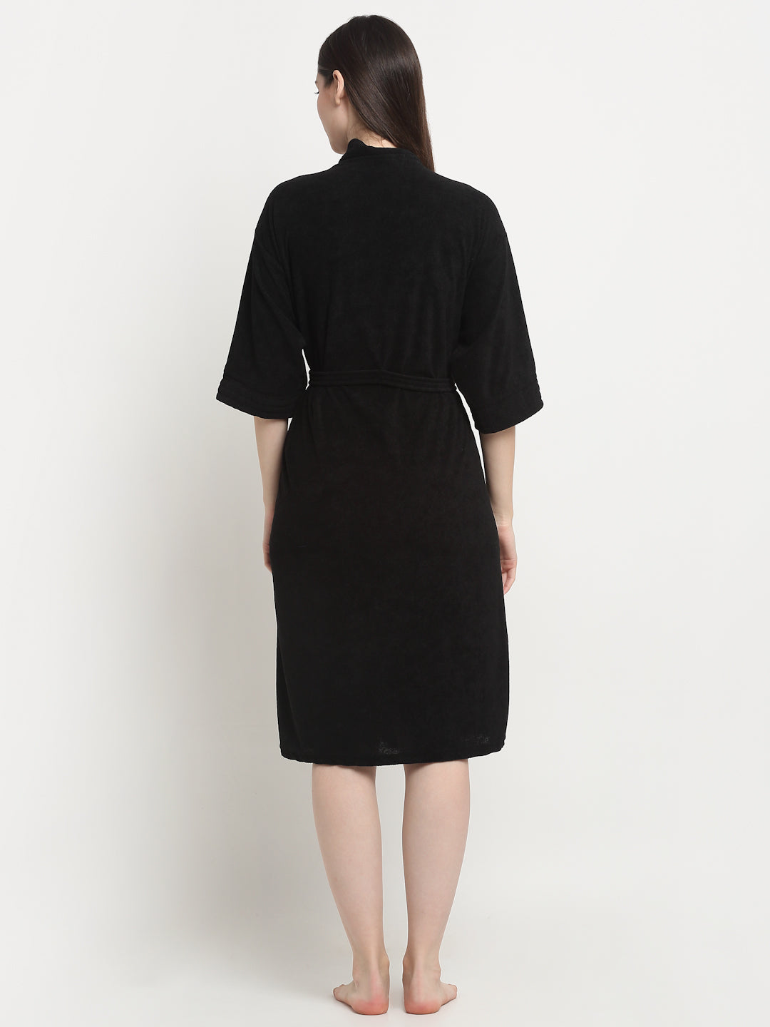 Backview of Woman wearing a black micro terry bathrobe with a tie belt 
