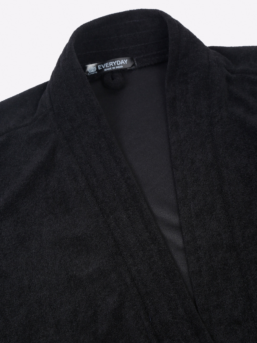 Close-up of a black micro terry bathrobe showing the collar and fabric texture