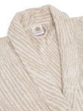 Close-up of a beige and off-white striped terry cloth robe with a white neck label featuring a gold crest.