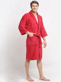 A Man wearing a crimson cotton bathrobe with a tie belt
