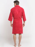 Back view of a woman wearing a crimson cotton bathrobe with a tie belt