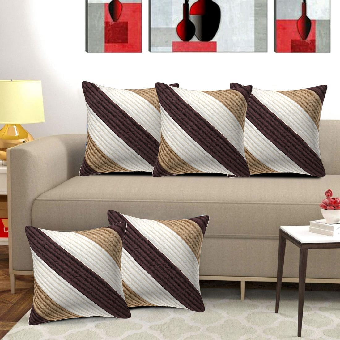 Decorative pillows with a geometric pattern on a beige sofa in a living room setting.