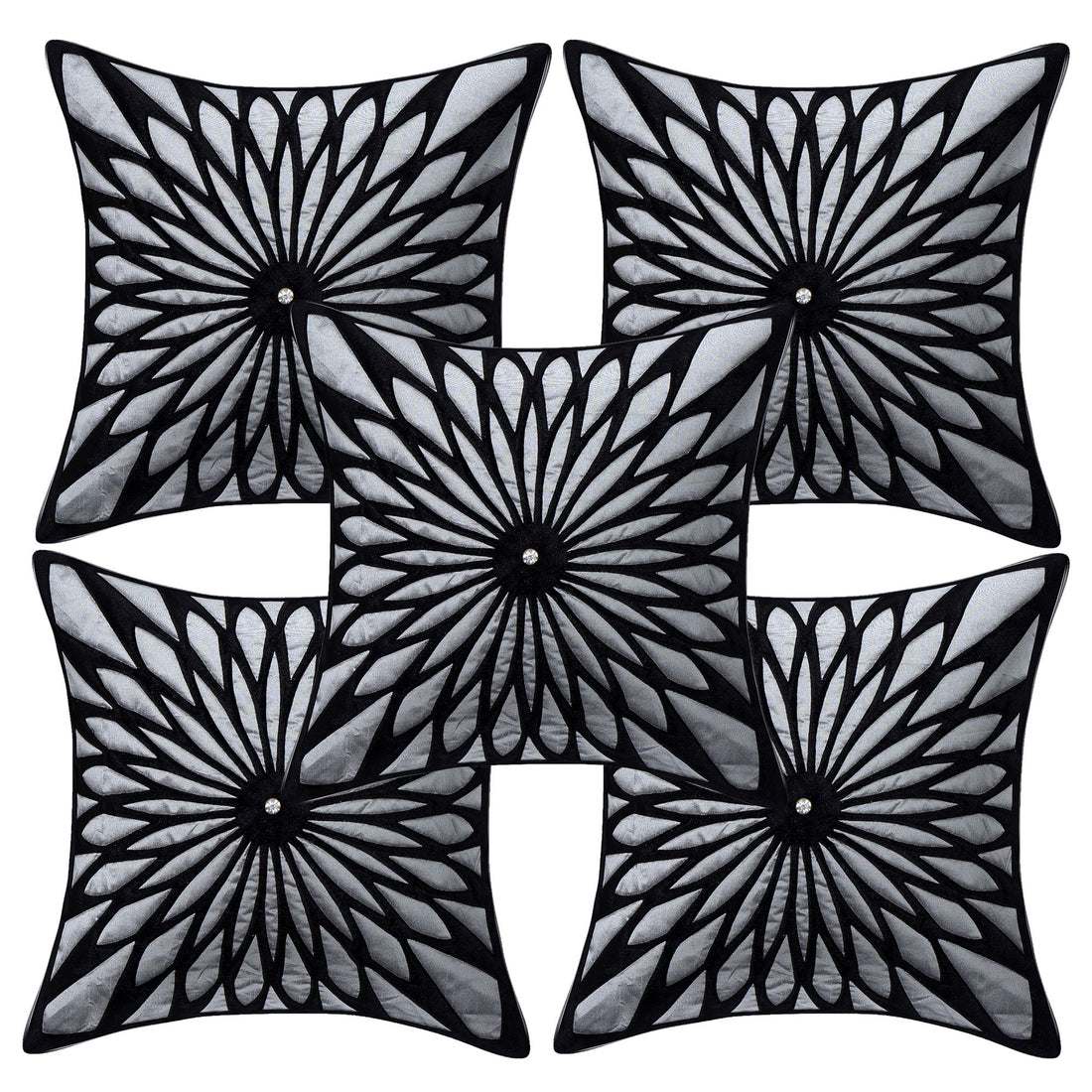 Black and white patterned pillows on a beige sofa with abstract art in the background.