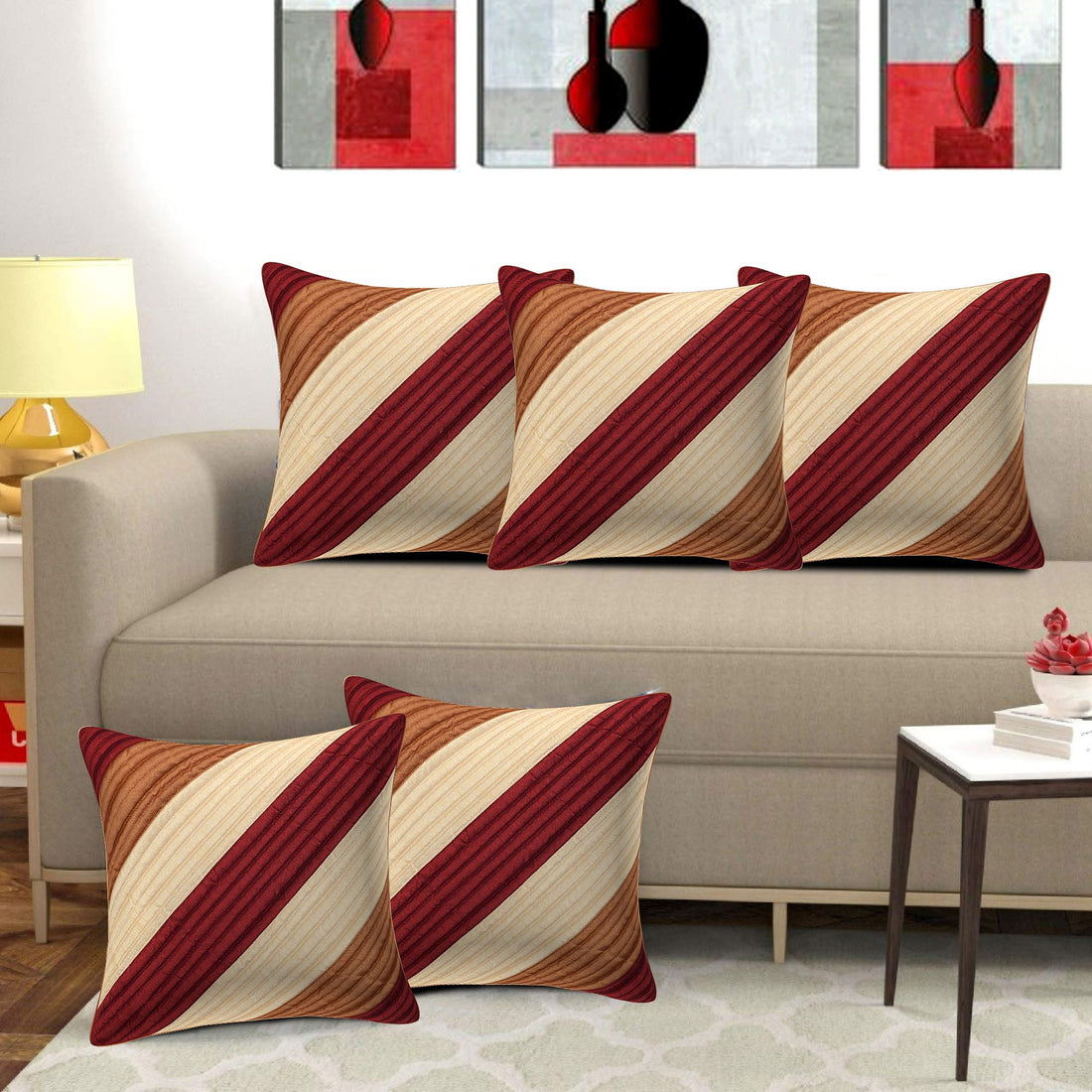 Decorative pillows with red and brown stripes on a beige sofa in a living room setting.