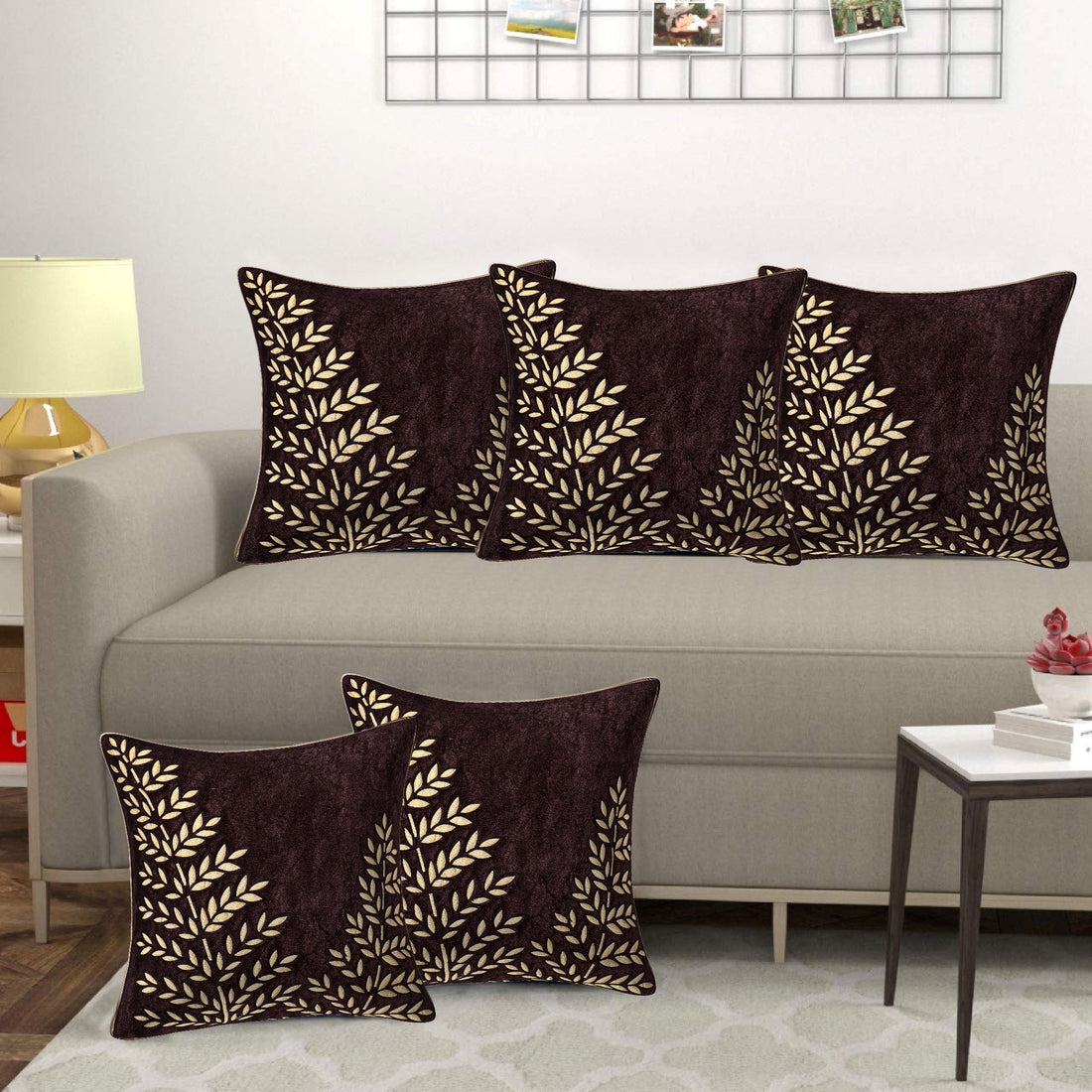 Decorative pillows with leaf pattern on a sofa in a living room setting.