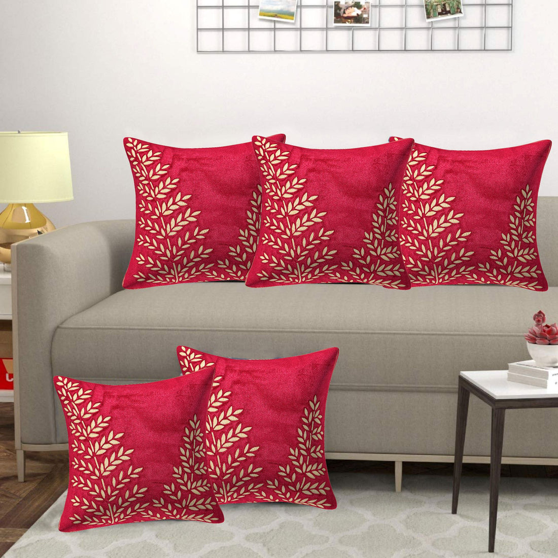 Red patterned pillows on a gray sofa in a living room setting.