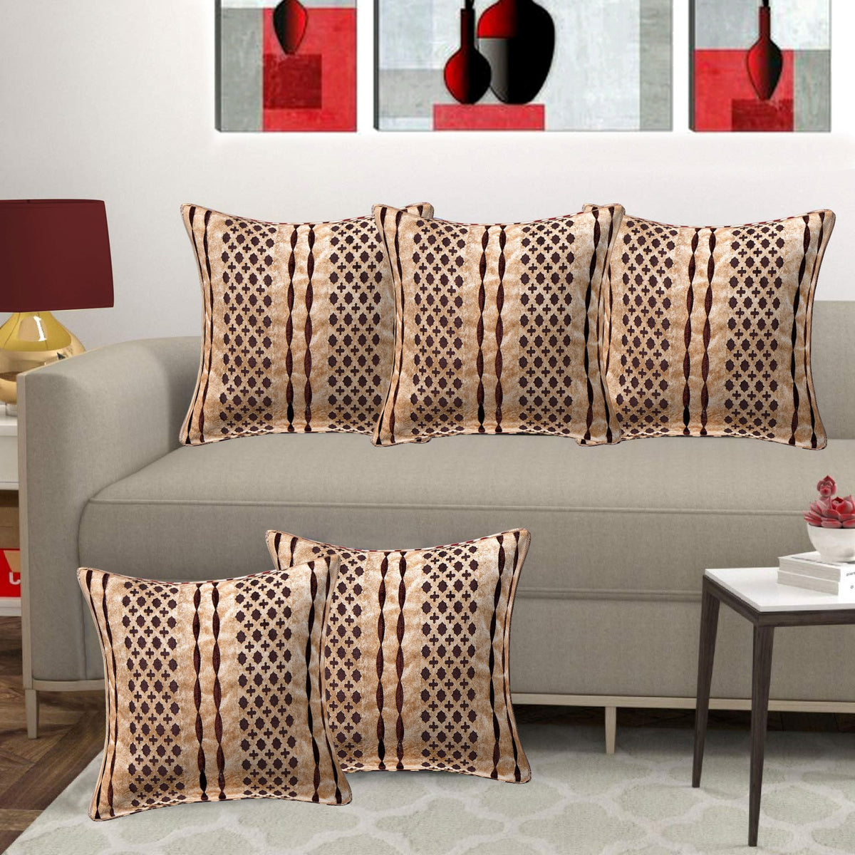 Patterned pillows on a gray sofa with a decorative wall art in the background