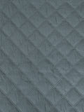 A close-up of a textured fabric with a repeating diamond quilted pattern in a muted slate blue-gray color.