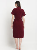 Back view of a woman wearing a grape wine micro terry bathrobe with a tie belt