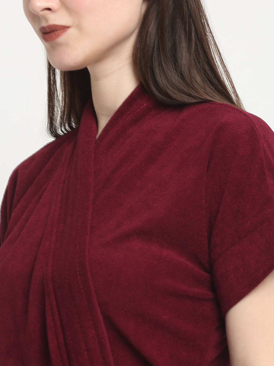 Close-up of a woman wearing a grape wine micro terry bathrobe with a tie belt
