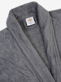 Close-up of a grey cotton bathrobe showing the collar and fabric texture
