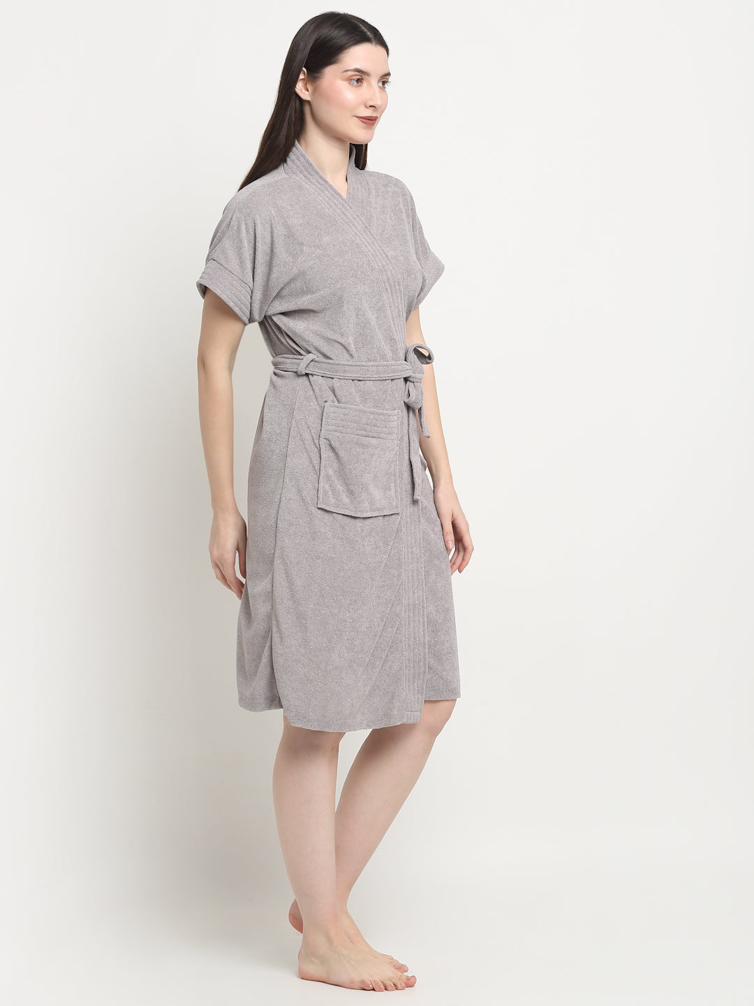 A Woman wearing a grey micro terry bathrobe with a tie belt