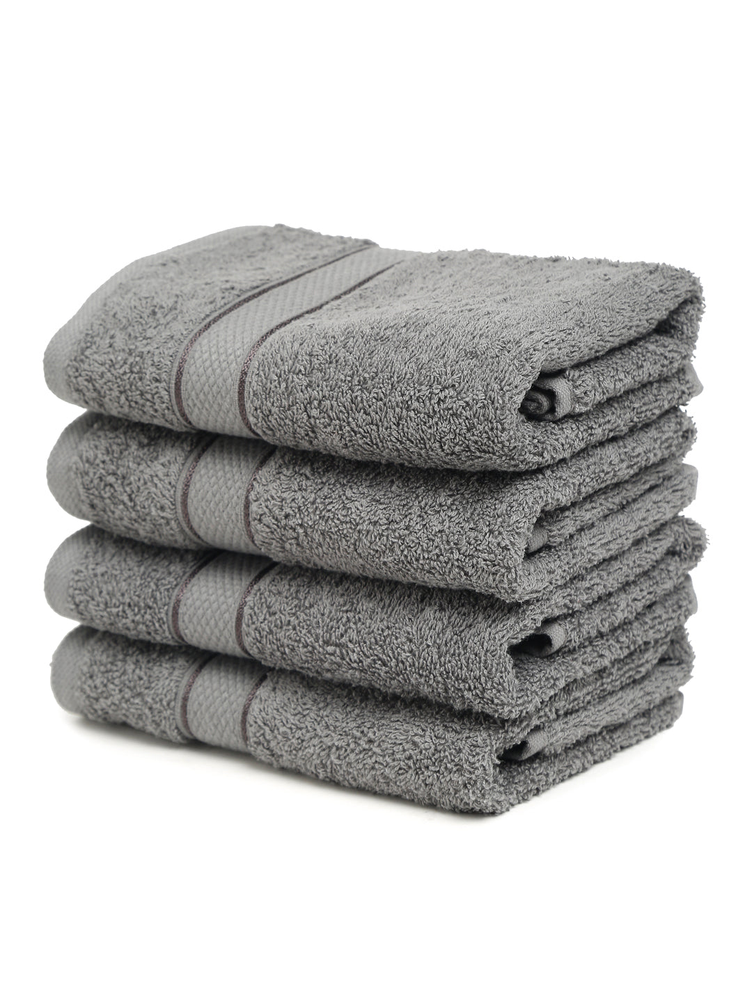 A set of grey Creeva brand hand towels stacked on a bathroom counter, with a wooden backdrop and a white background.
