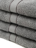 4 Stacked grey cotton towels with textured terry fabric and decorative stripe detailing.