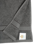 Grey cotton hand towel showing a close-up of the terry texture, decorative stripe detailing, and CREEVA label.