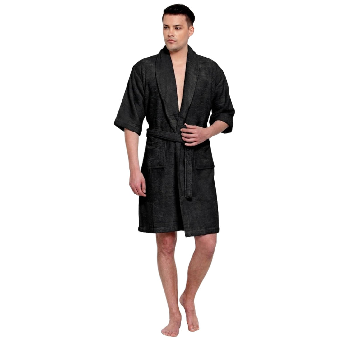 A man modeling a black textured bathrobe with a shawl collar, waist tie, and front pockets against a plain white background.