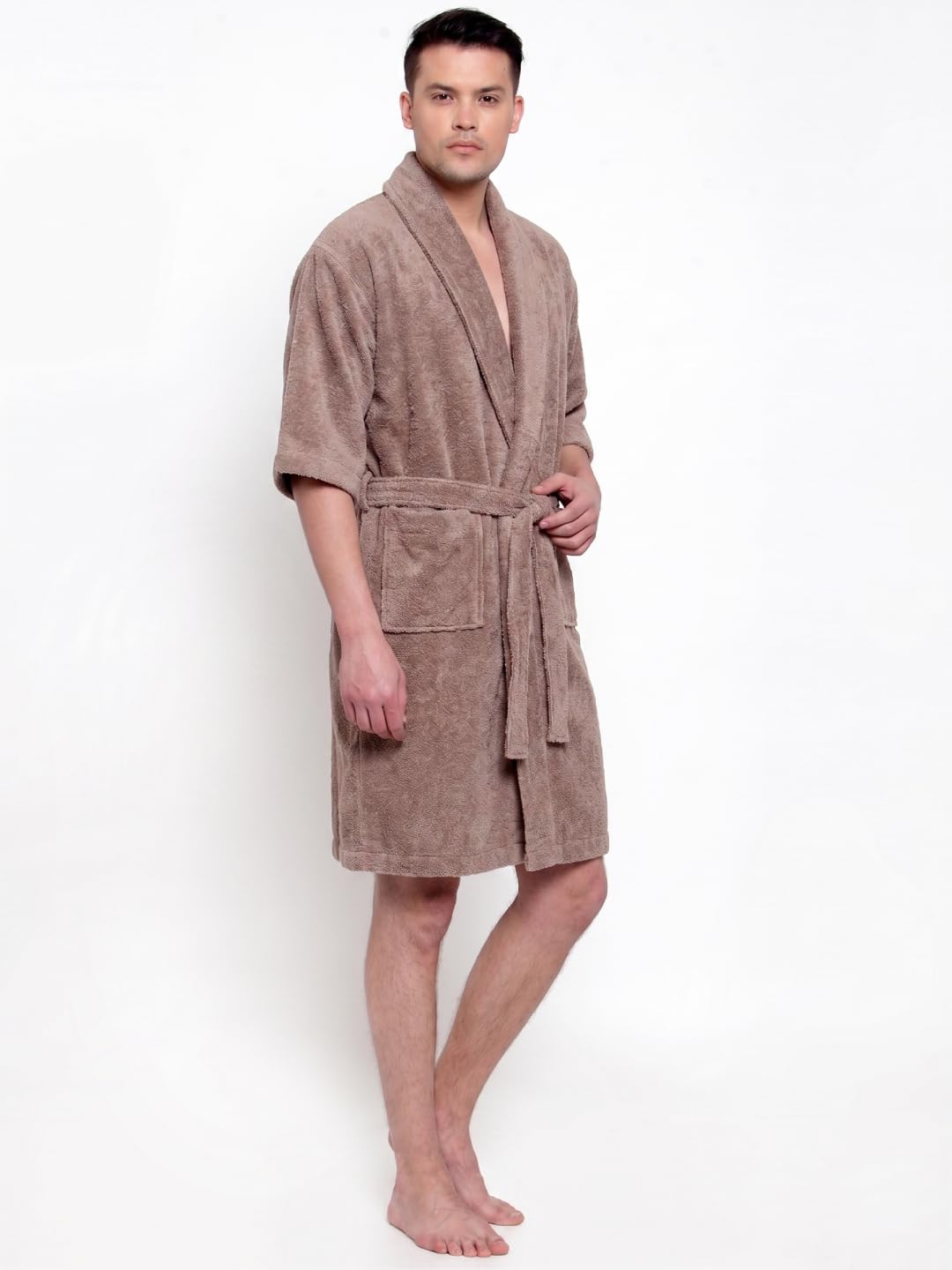 A man modeling a short-sleeved brown terry cloth bathrobe against a plain white background.