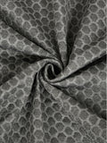 Close-up of textured grey mattress cover fabric with a geometric pattern