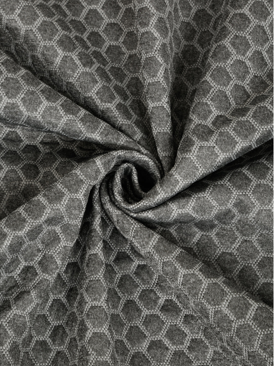 Close-up of textured grey mattress cover fabric with a geometric pattern
