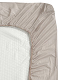 Close-up side view of a Creeva mattress cover with elasticated fitted edge