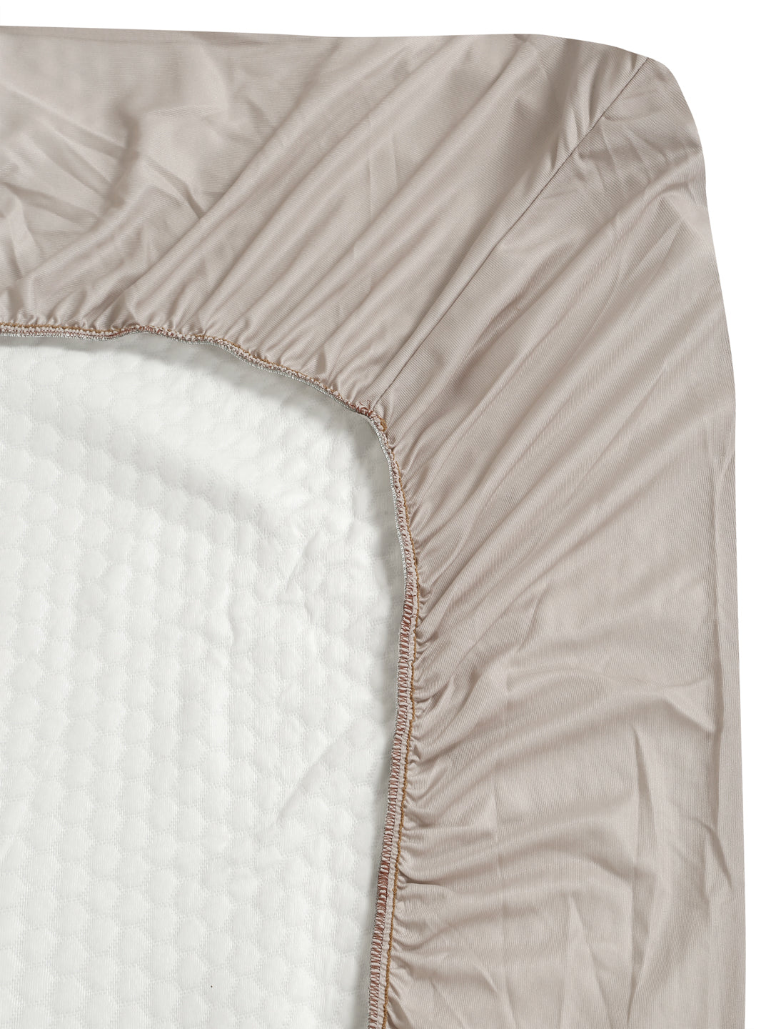 Close-up side view of a Creeva mattress cover with elasticated fitted edge