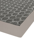 A close-up of a gray and white geometric patterned rug with a solid taupe-beige underside, shown on a white background.