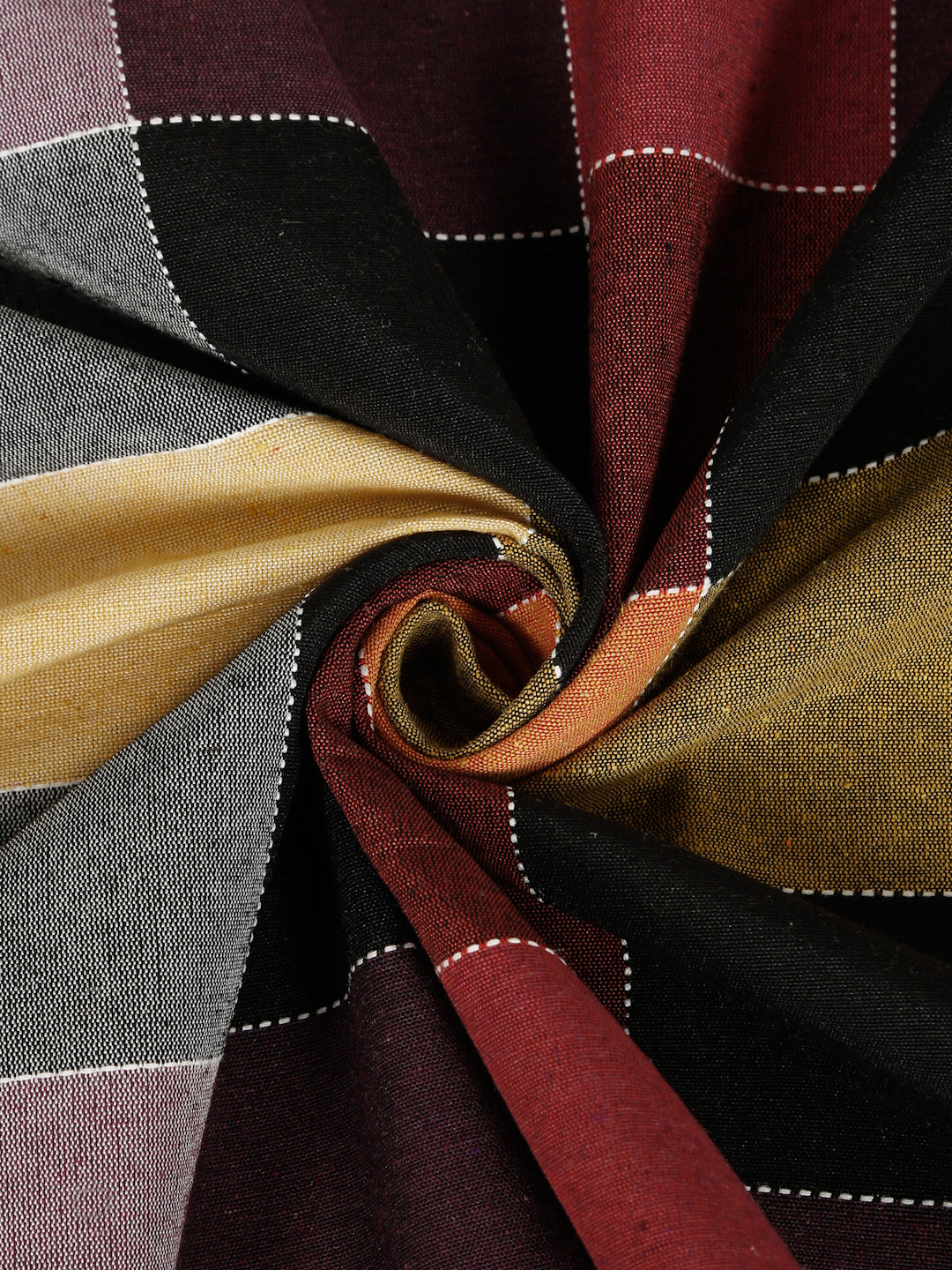 A close-up of a draped plaid fabric with a spiral twist, showing stripes of black, deep red, mustard yellow, gray, and white dashed lines.