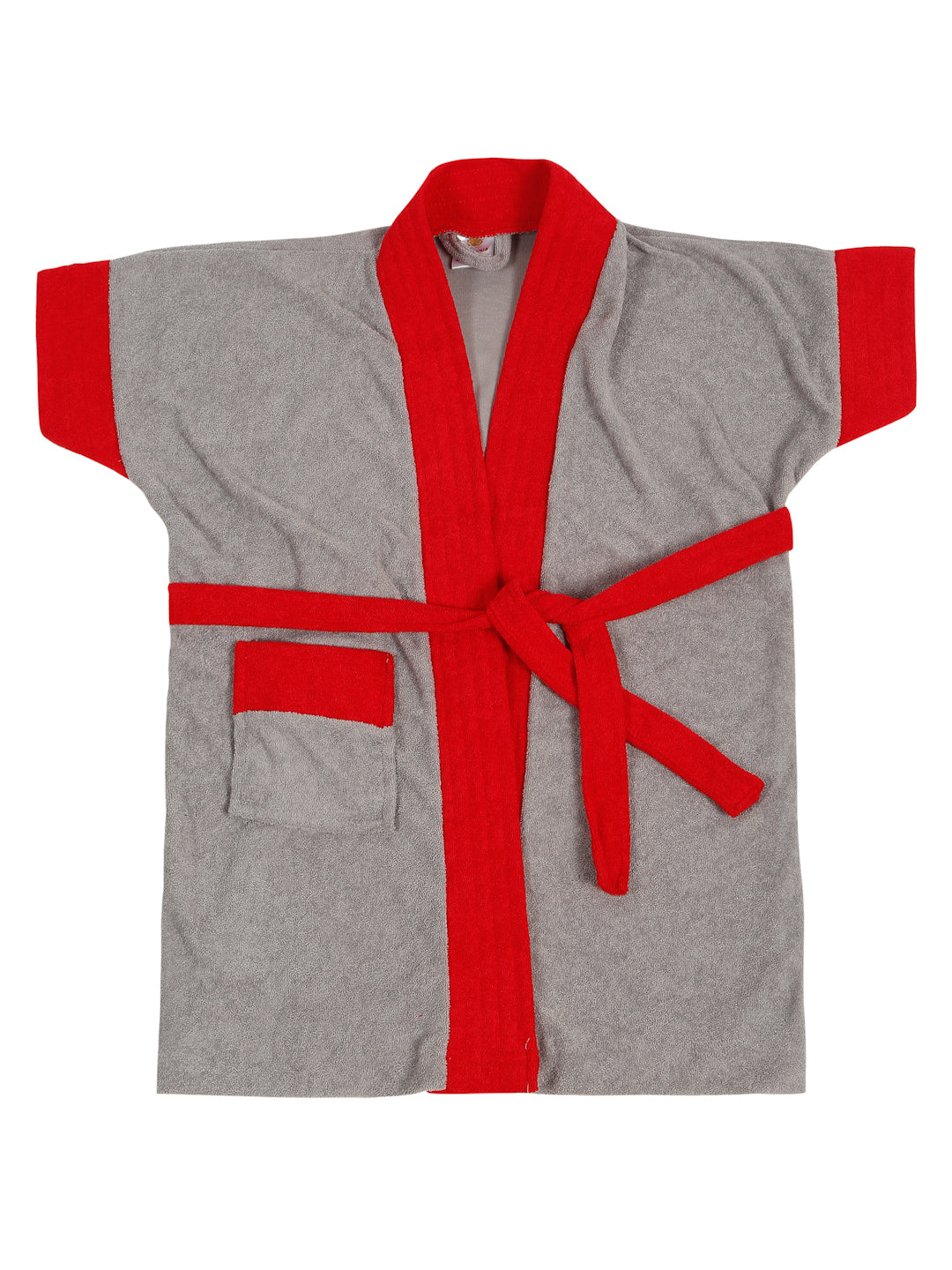 Child wearing a gray robe with red trim in a home setting