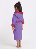 Child wearing a purple and red robe on a white background