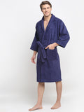 A Man wearing a navy blue cotton bathrobe with a tie belt