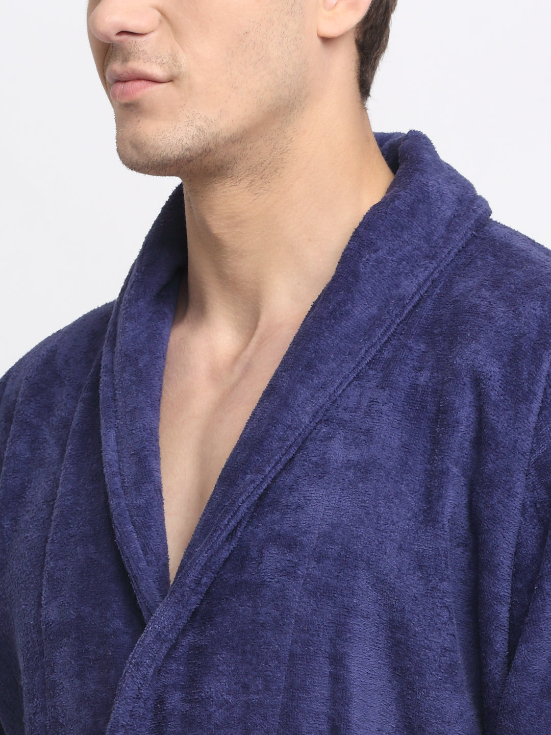 Close-up of a man wearing a navy blue cotton bathrobe with a tie belt