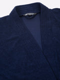 Close-up of a navy blue micro terry bathrobe showing the collar and fabric texture
