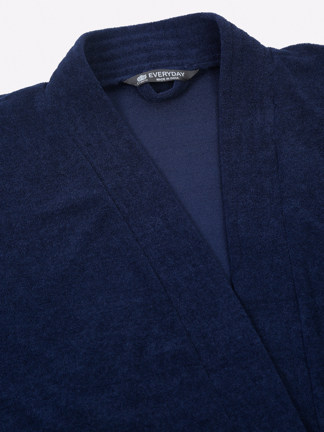 Close-up of a navy blue micro terry bathrobe showing the collar and fabric texture