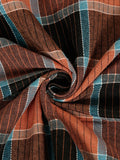 A close-up of a plaid fabric swirled in the center, showing a pattern of rust orange, black, teal blue, and thin white stripes.