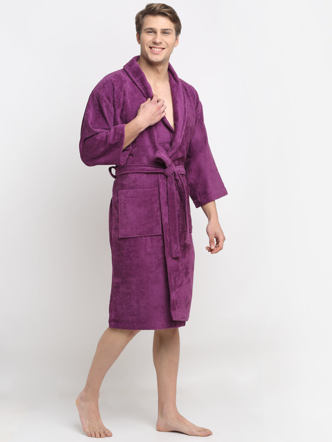 A Man wearing a purple cotton bathrobe with a tie belt