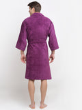 Back view of a man wearing a purple cotton bathrobe with a tie belt